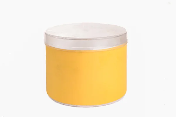 Round yellow plastic container with silver cap — Stock Photo, Image