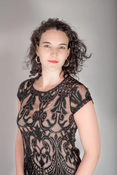 Portrait of a young woman with black hair and black blue dress.. — Stock Photo, Image