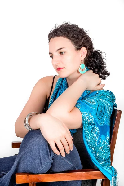 Portrait of a young woman with black hair and blue top. — Stock Photo, Image