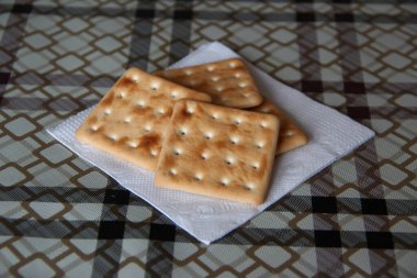 Mutfak masasındaki peçetenin üzerinde düşük kalorili bisküviler var.