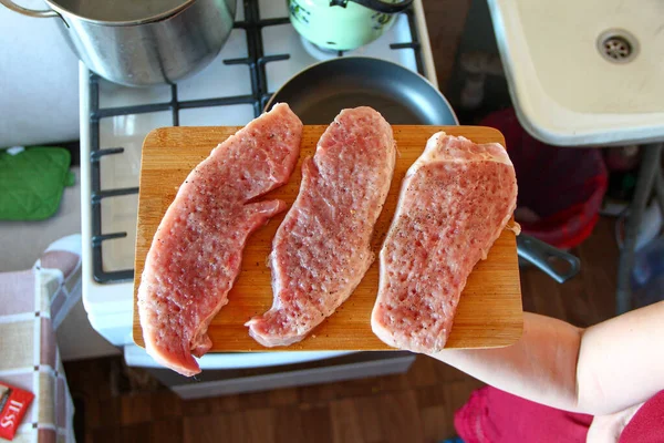 Vrouwenhanden Met Drie Rauwe Karbonades Met Specerijen Een Snijplank Boven — Stockfoto