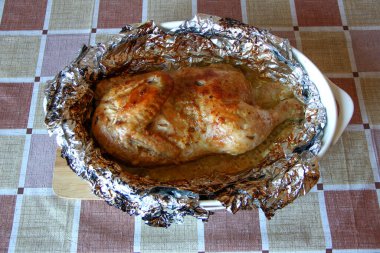 Baharatlı folyoda pişmiş yarım tavuk.