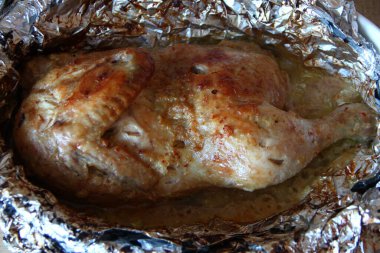 Baharatlı folyoda pişmiş yarım tavuk.