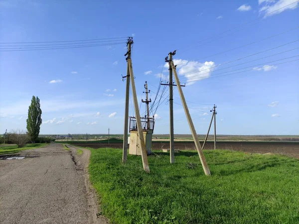 Old transformer box and electric lines in the countryside