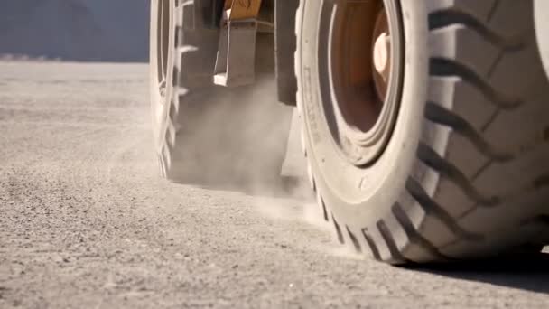 Close-Up Shot Of Heavy Machinerys Wheels Moving Forward On A Dusty Road — Stock Video