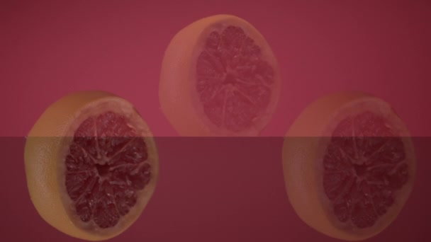 Three Fresh Grapefruit Slices Tossed Up Flying Hanging In The Air (dalam bahasa Inggris). — Stok Video