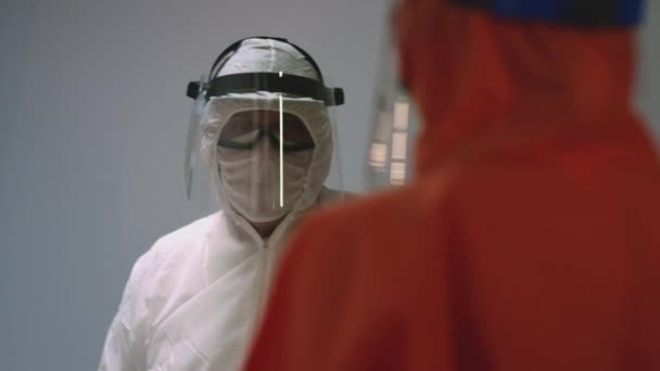 Doctors in Protective Suits Consult Coronavirus Patients Status — Stock Video