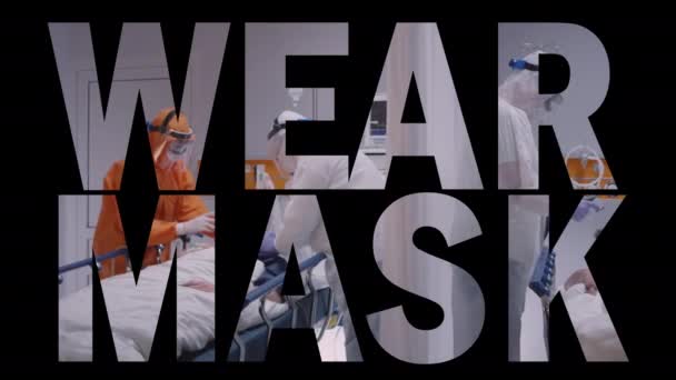 WEAR MASK 2D Text mit Aufnahmen aus dem Quarantäne-Krankenhauszimmer im Hintergrund — Stockvideo