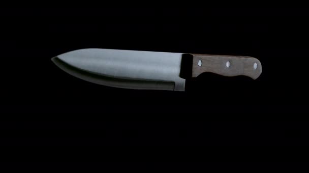 Cuchillo de cocina girando y cayendo sobre fondo negro — Vídeos de Stock