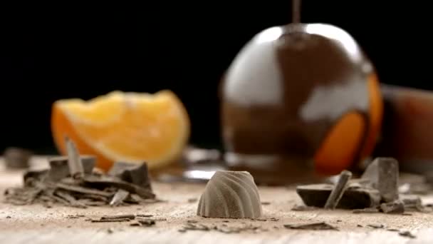 Slowmo Packshot of Praline with Oranges in the Background — Stock Video