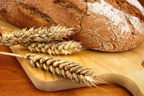 Baked loaf with wheat — Stock Photo, Image