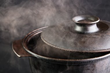 Steaming iron pot with opened cover clipart