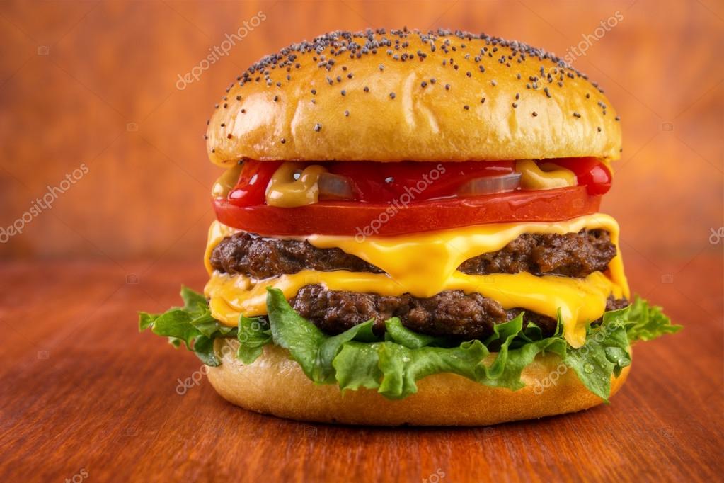 Double cheeseburger with tomato, onion, mustard and ketchup Stock Photo