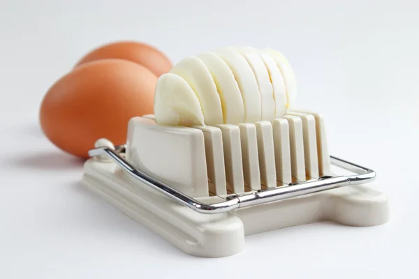 Egg slicer and boiled eggs — Stock Photo, Image