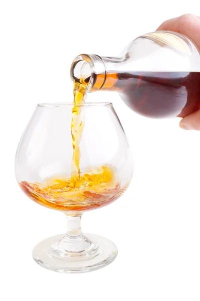 Pouring cognac into glass — Stock Photo, Image