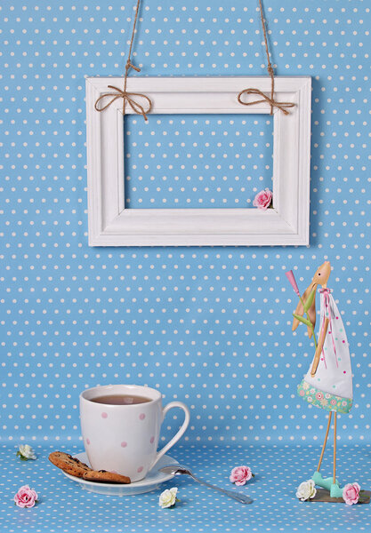 Cup of tea and a white frame on a blue background