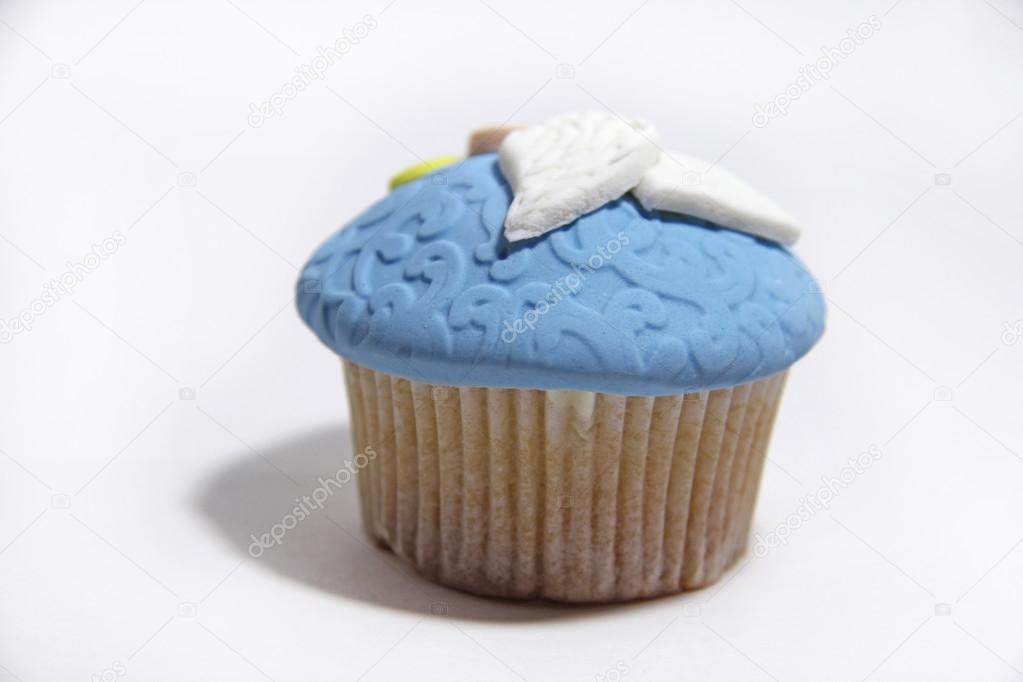 Blue sweet mastic cupcake on white