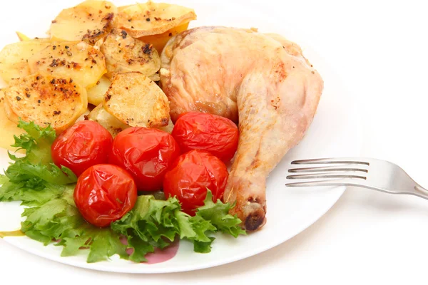 Fried chicken leg with potatoes and marinated tomatoes — Stock Photo, Image
