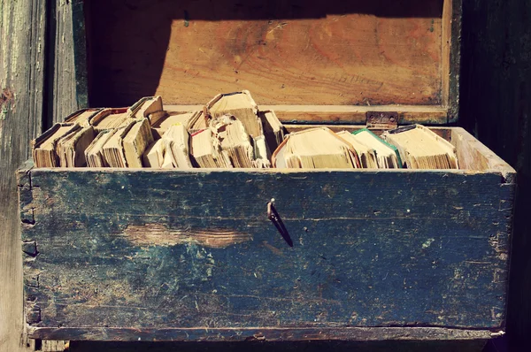 Old books in a wooden blue chest. Old books