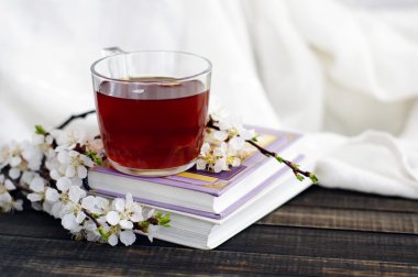  Books, blossoming apricot branch and a cup of tea  clipart