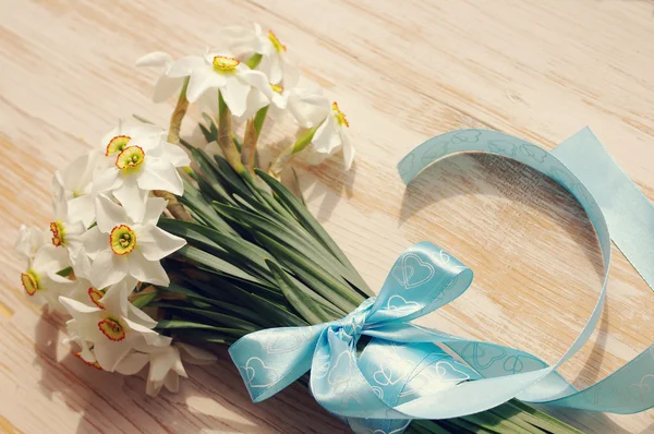 Narcissus boeket ingericht met een blauwe strik — Stockfoto