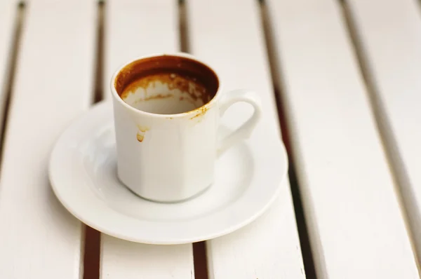 Empty white coffee cup on a saucer on a white tabl. — Stock Photo, Image