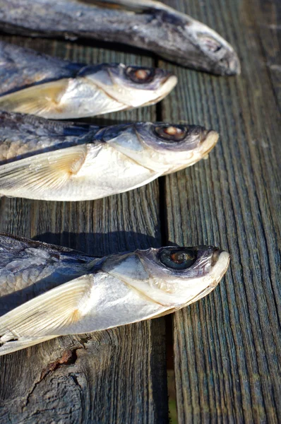 Salty fish on a old wooden table — Stock Photo, Image