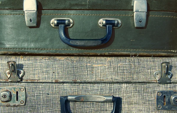 Handles of old suitcases close up.