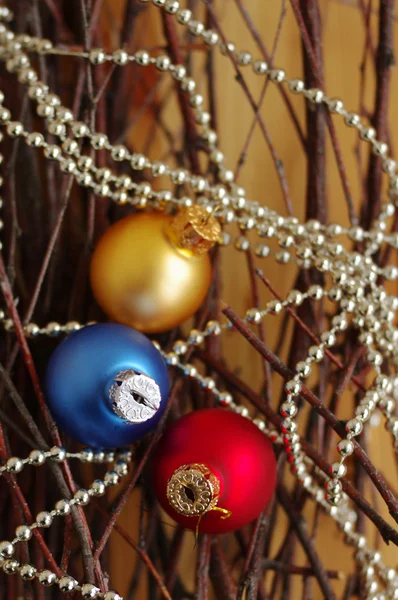 Three multi-colored New Year's balls on brilliant garlands — Stock Photo, Image