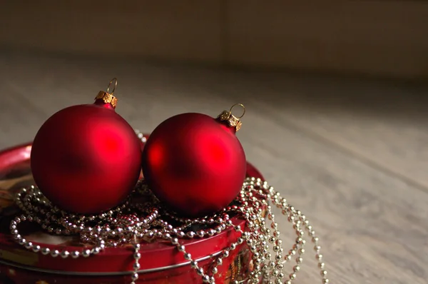 Red New Year's toys spheres on bright brilliant jewelry — Stock Photo, Image