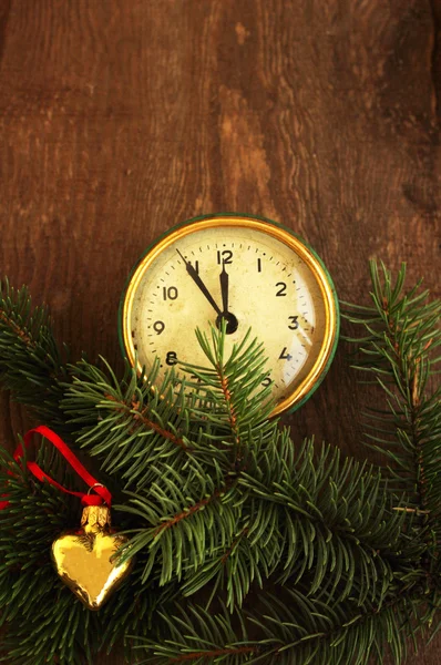 New Year's toys and old hours on a wooden background — Stock Photo, Image