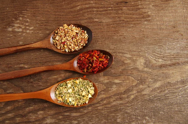 Spices in wooden spoons — Stock Photo, Image