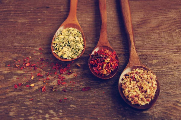 Spices in wooden spoons — Stock Photo, Image