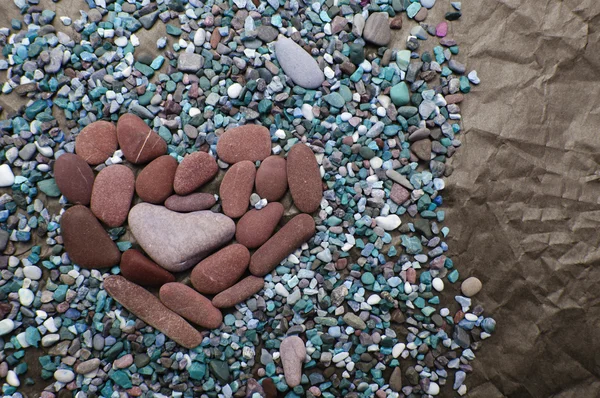 Sea color stones in the form of heart against crumpled black paper — Stock Photo, Image