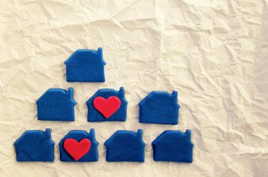 Two red hearts in blue lodges from plasticine on the white rumpled made old paper clipart
