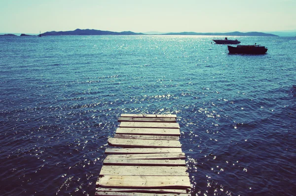 Old wooden pier from boards going to the sea — Stock Photo, Image