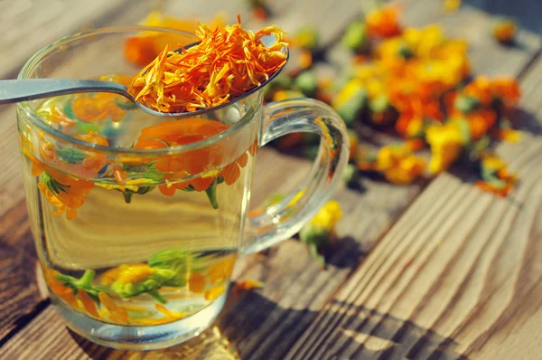 Herbal tea from flowers of a marigold — Stok fotoğraf