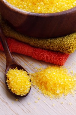 Aromatic salt for Spa therapies in a wooden bowl, with a towel. Alternative medicine. Care of a body.