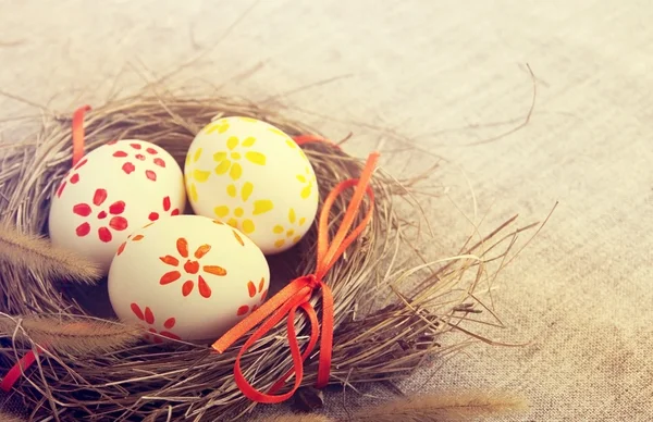 Easter eggs with bright tapes in a nest — Stock Photo, Image
