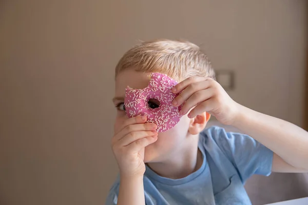 Concept Useless Food Little Boy Blond Hair Eats Pink Doughnut — Stock Photo, Image