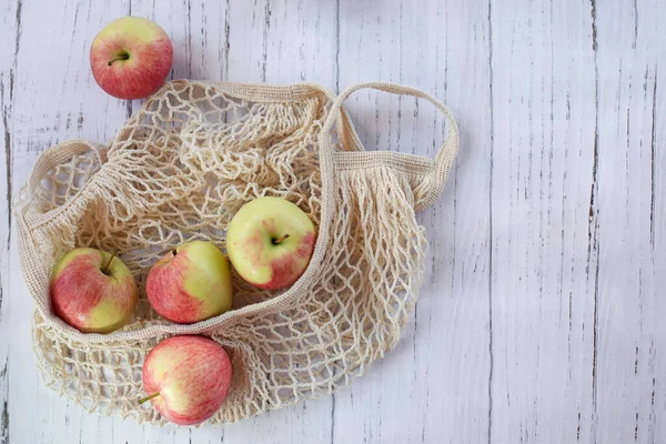 Ripe Delicious Red Apples Mesh Bag Light Wooden Background Top — Stock Photo, Image