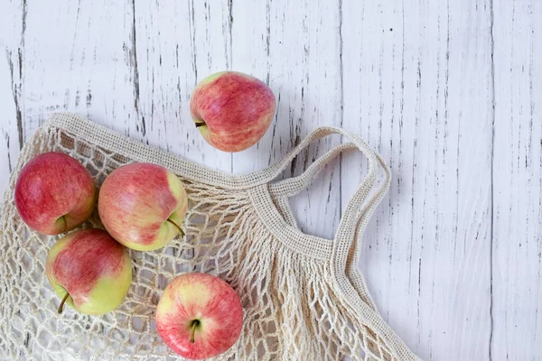 Ripe Delicious Red Apples Mesh Bag Light Wooden Background Top — Stock Photo, Image