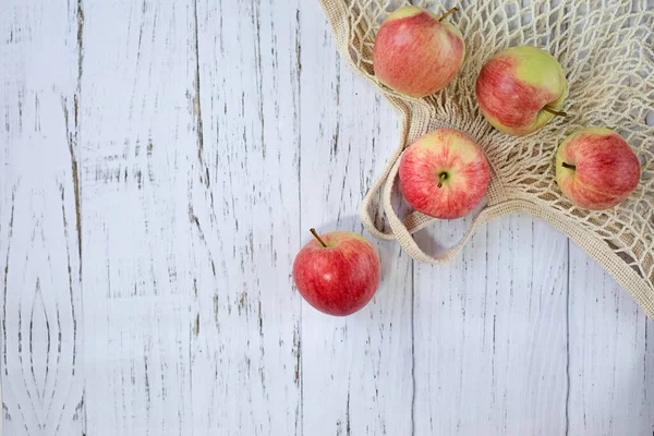 Ripe Delicious Red Apples Mesh Bag Light Wooden Background Top — Stock Photo, Image