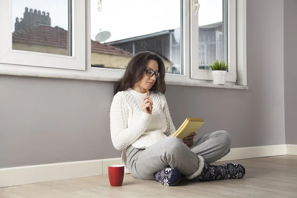 Donna pensierosa leggere una cosa a casa — Foto Stock