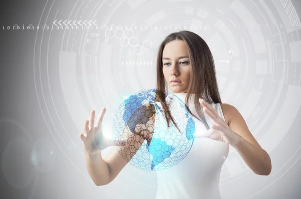 Young woman working with earth globe hologram — Stock Photo, Image