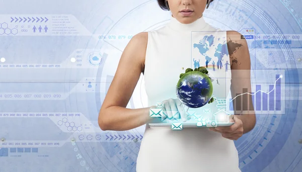 Businesswoman with tablet pc against high-tech background — Stock Photo, Image