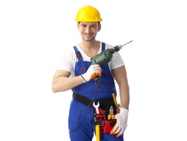 Smiling handyman holding drill machine