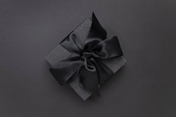 Black gift box on black background for Black Friday concept