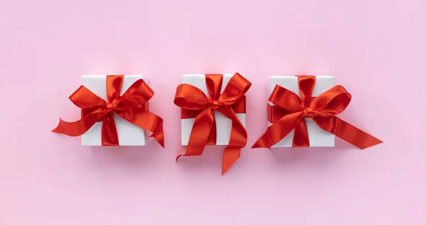 Christmas Holiday Composition Three Gift Boxes Red Ribbon Pastel Pink — Stock Photo, Image