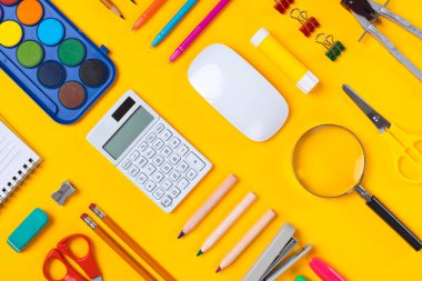 School supplies flat lay on yellow background clipart